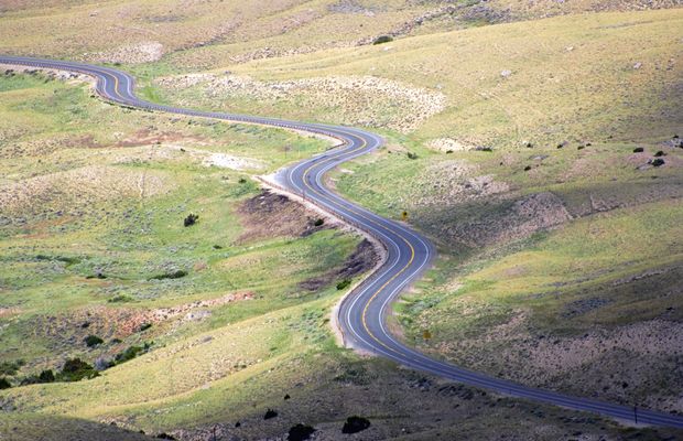 A road winding up through high grassland
