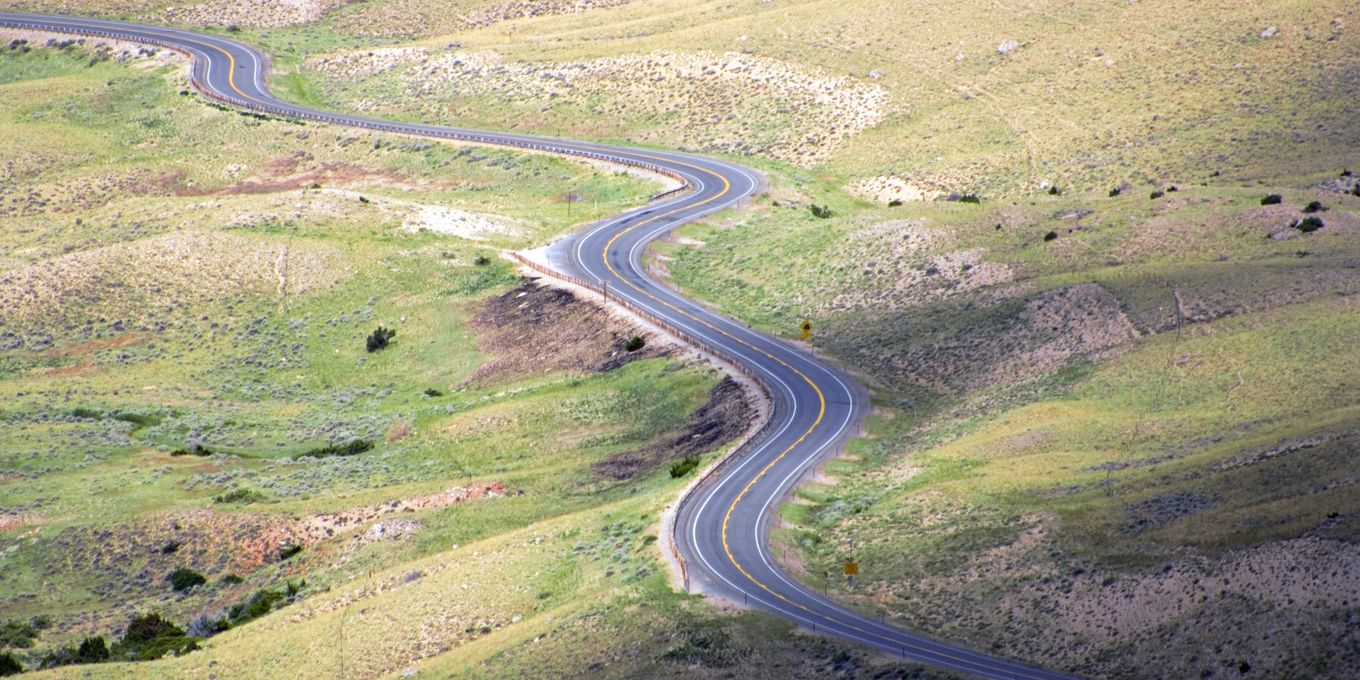 A road winding up through high grassland