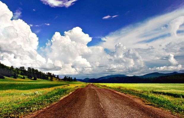 A dirt road running across a valley toward the mountains